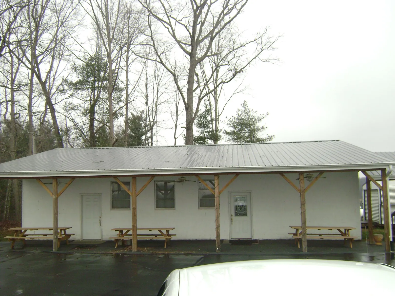 Gray metal roof over a block building with a timber post porch in Winchester